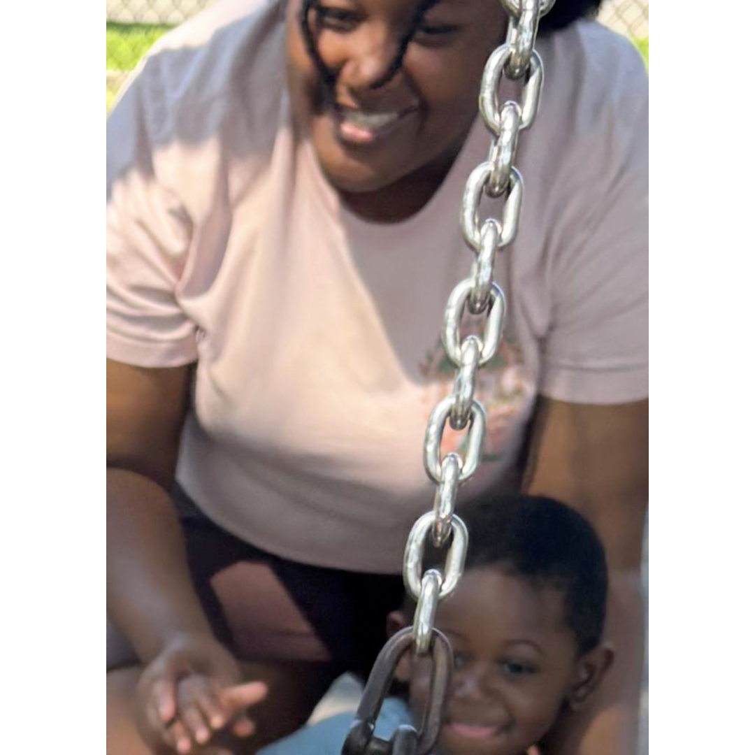 A parent and child enjoying the playground at El Elyon Bee's Daycare